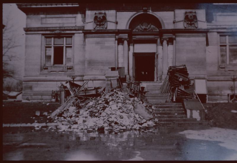 Photograph from the 1937 flood depicting hundreds of damaged books on the steps of the old Carnegie Library in Jeffersonville