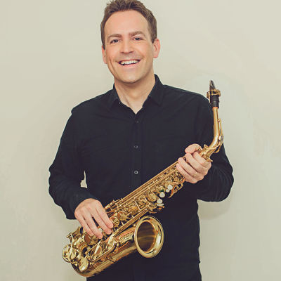 Daniel Bennett posing with his alto saxophone