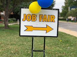 Image of yard sign saying "Job Fair" with balloons tied to top of sign