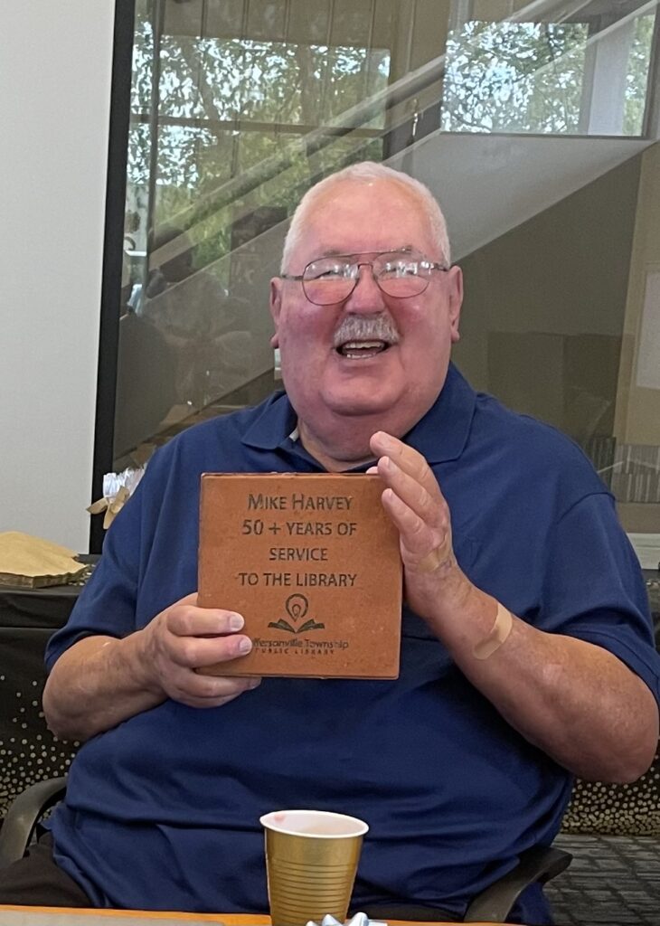 Photo of Mike Harvey holding a red paver