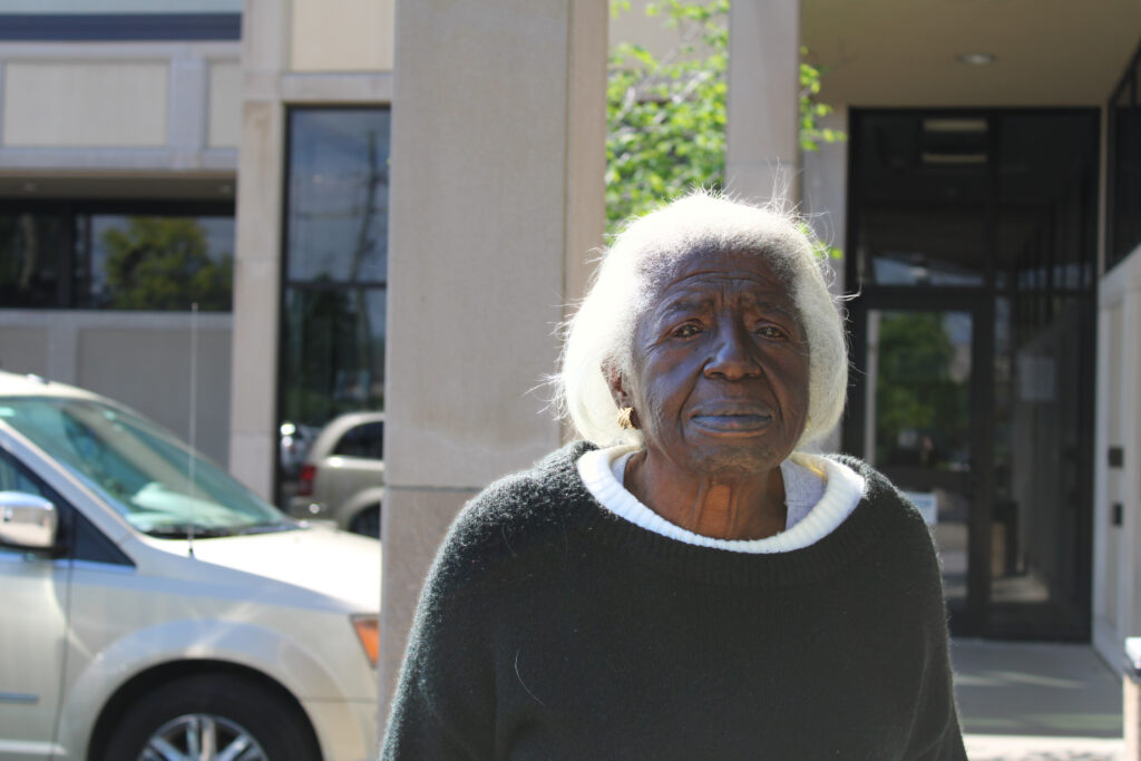 Flora poses in front of the Jeffersonville library.